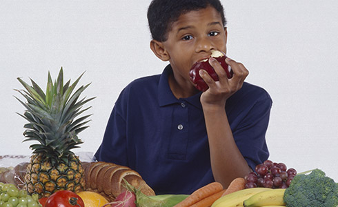 A boy eating fruit.